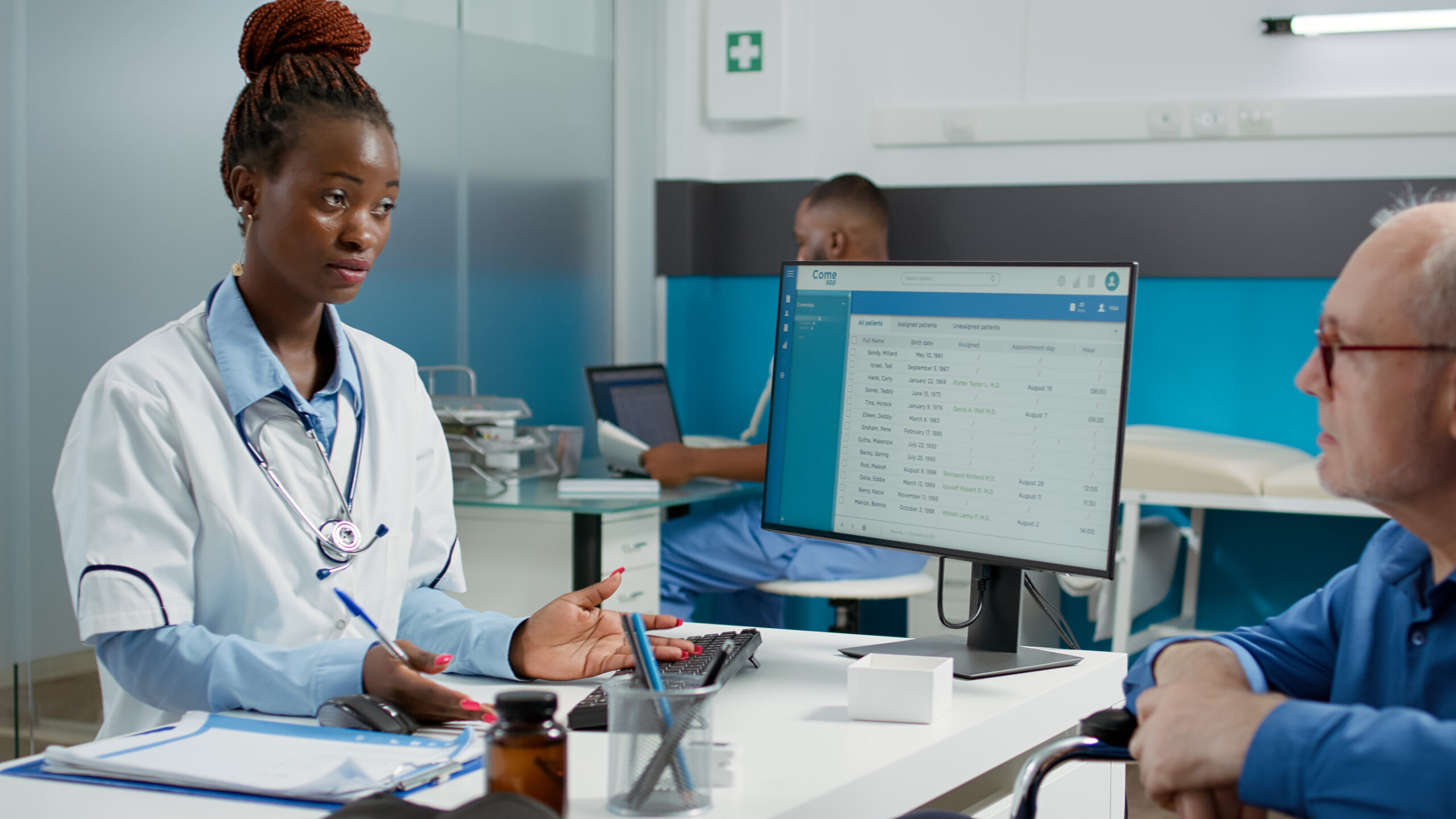 Female Physician Consulting Elderly Man With Physical Impairment Having Medical Appointment Office Doctor Talking Patient Wheelchair User With Disability Giving Healthcare Support